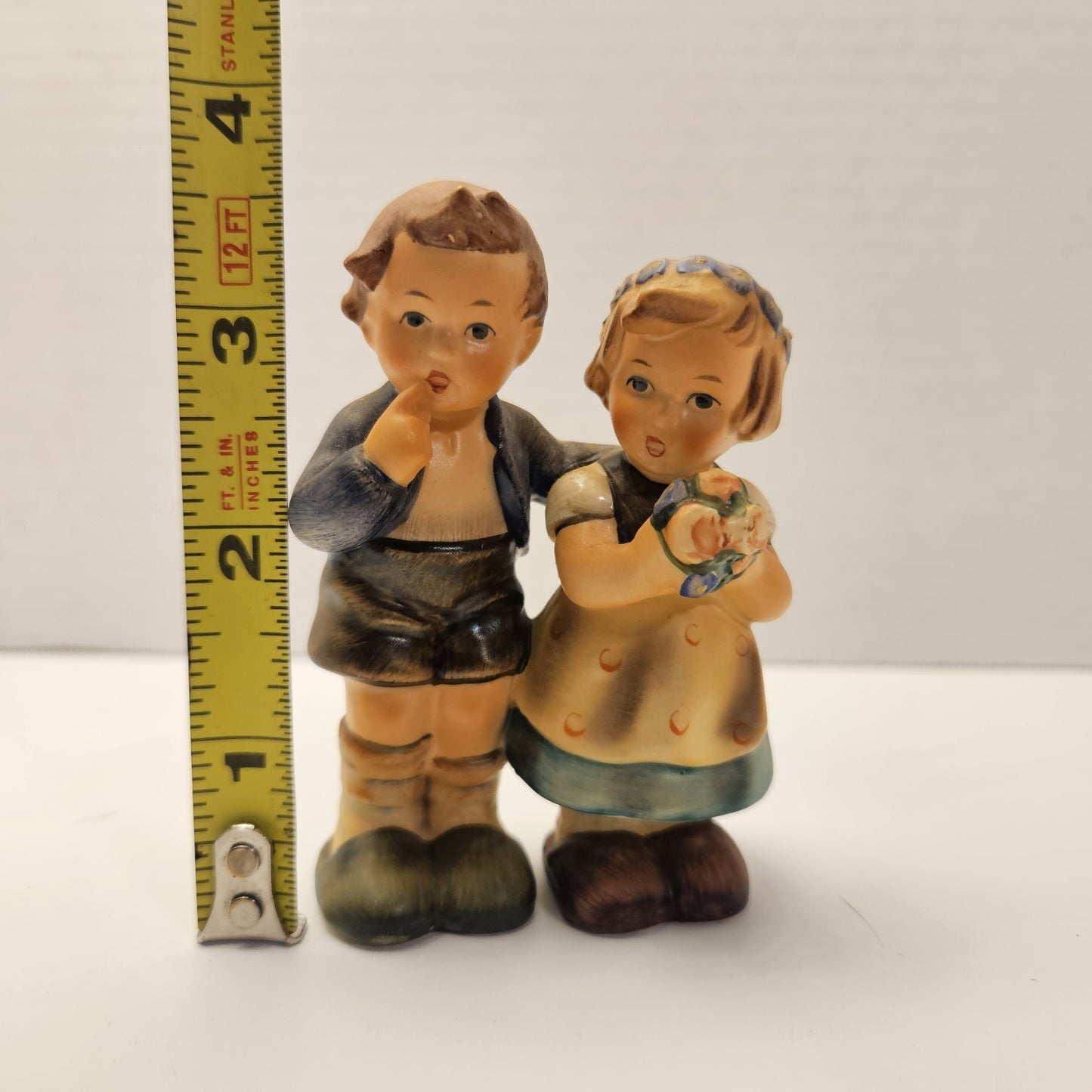 vintage ceramic figurine is a "We Congratulate" piece from M.I. Hummel