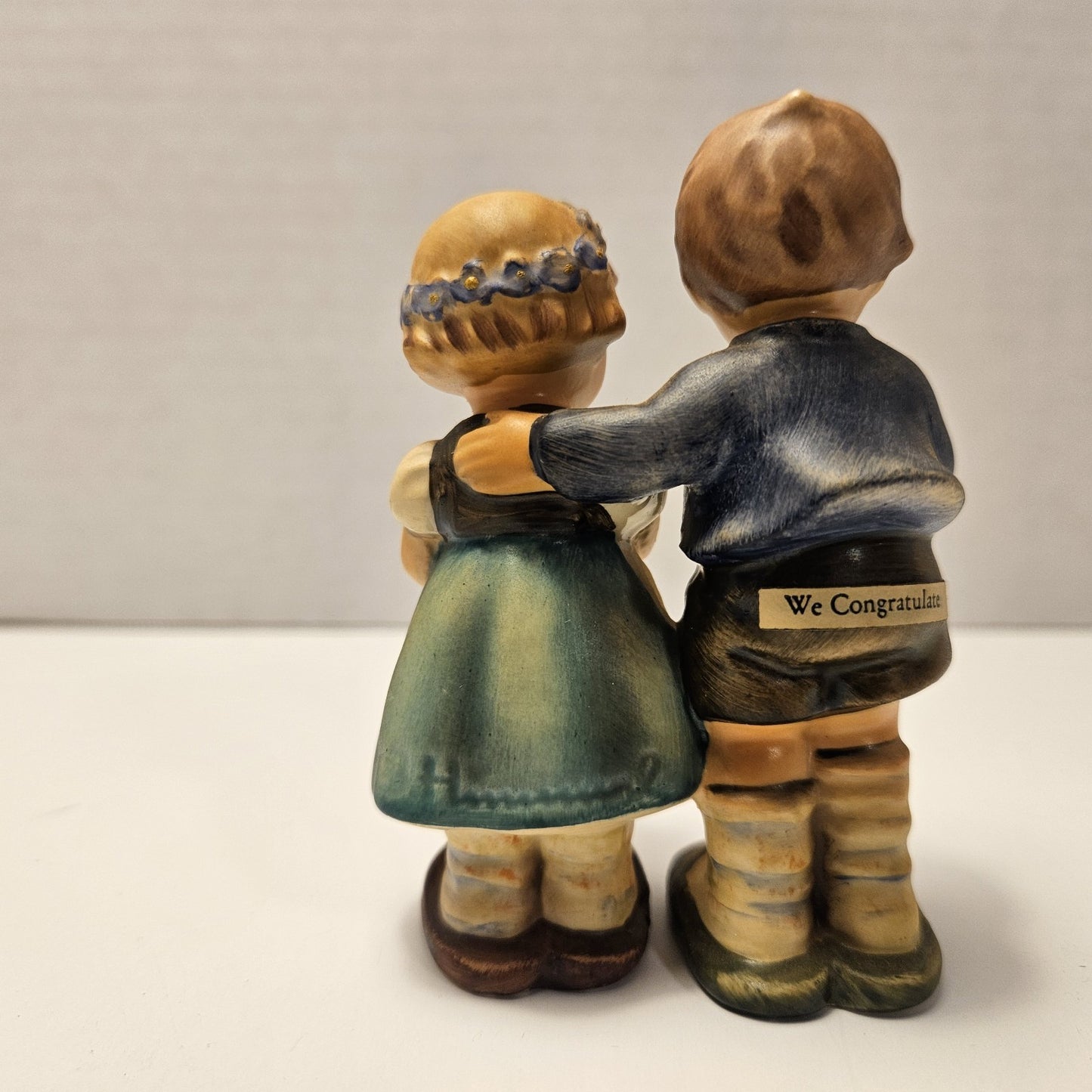 vintage ceramic figurine is a "We Congratulate" piece from M.I. Hummel