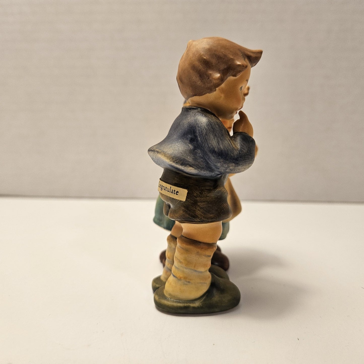 vintage ceramic figurine is a "We Congratulate" piece from M.I. Hummel