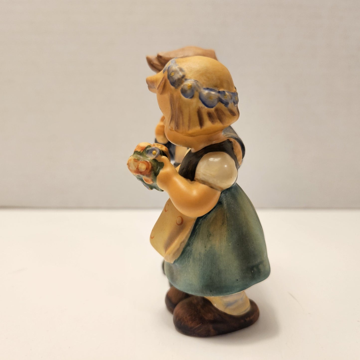 vintage ceramic figurine is a "We Congratulate" piece from M.I. Hummel
