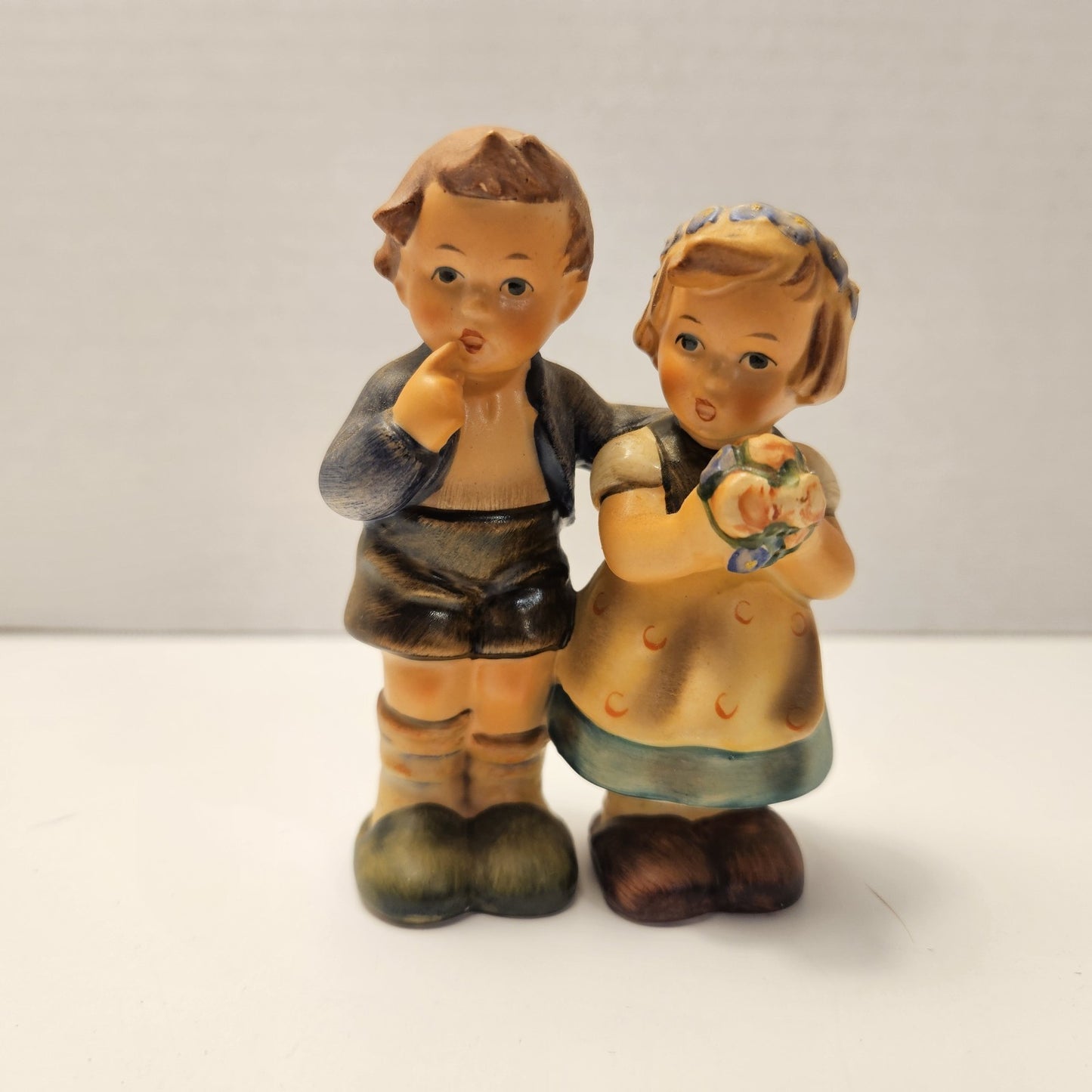 vintage ceramic figurine is a "We Congratulate" piece from M.I. Hummel