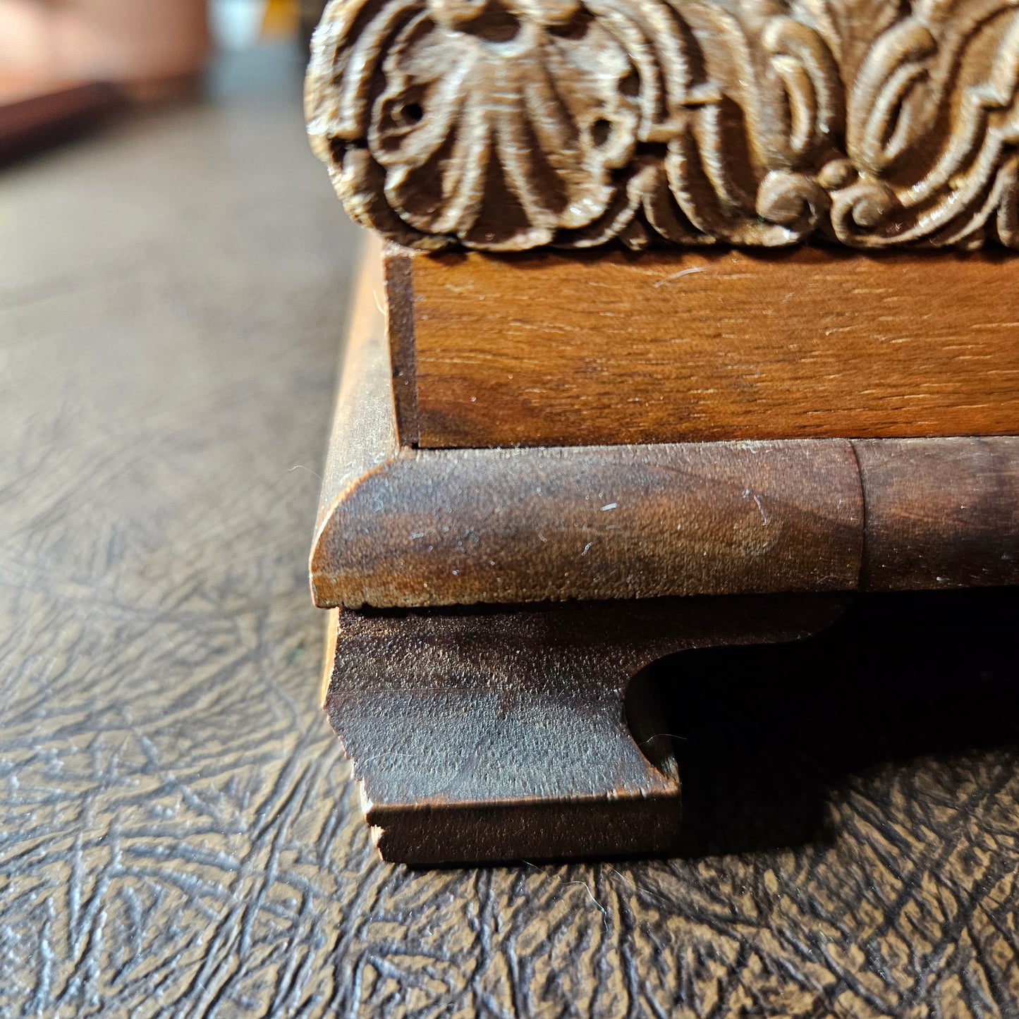Wooden leg on a music box. Leg is slightly chipped.