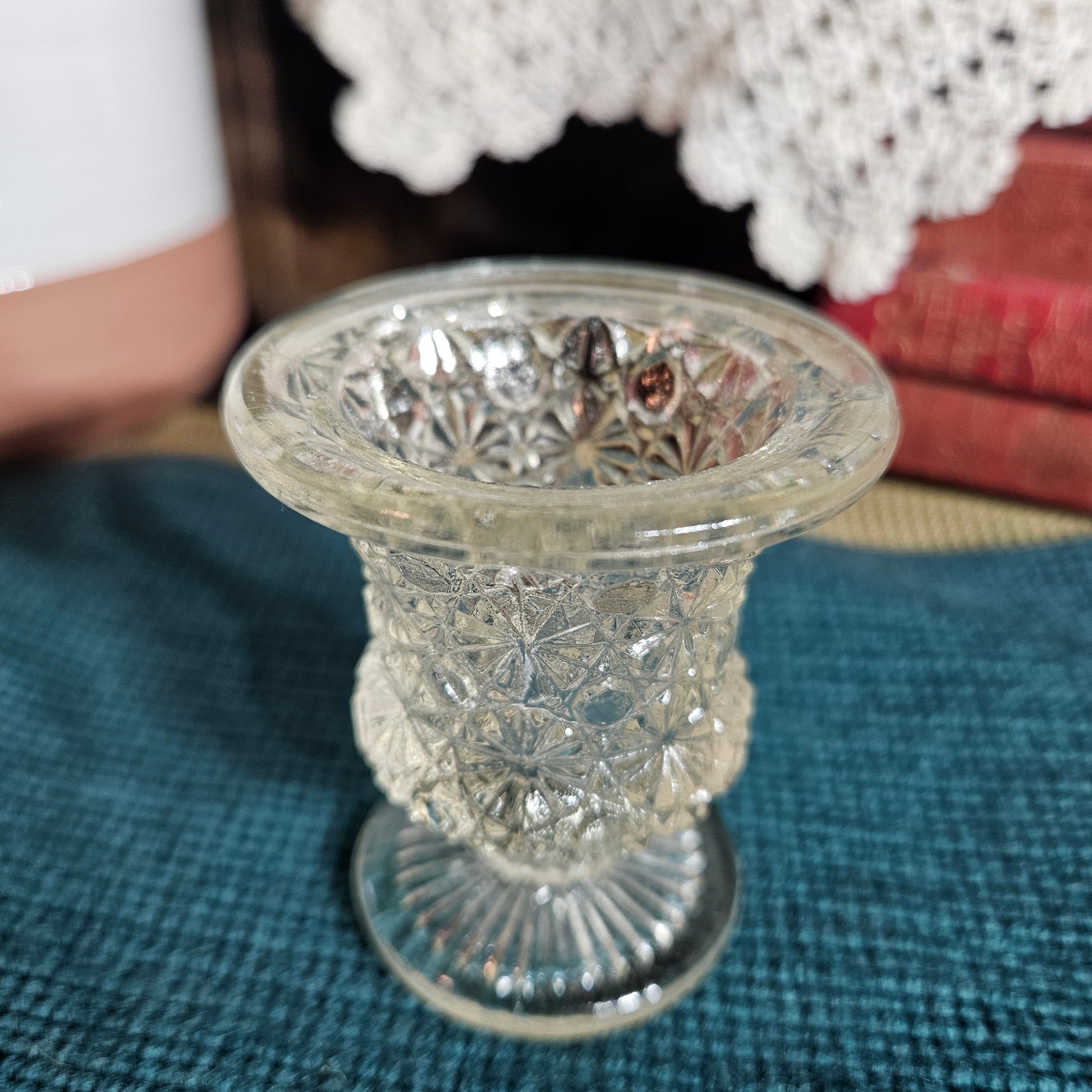 Decorative toothpick holder on a textured surface with a blurred background