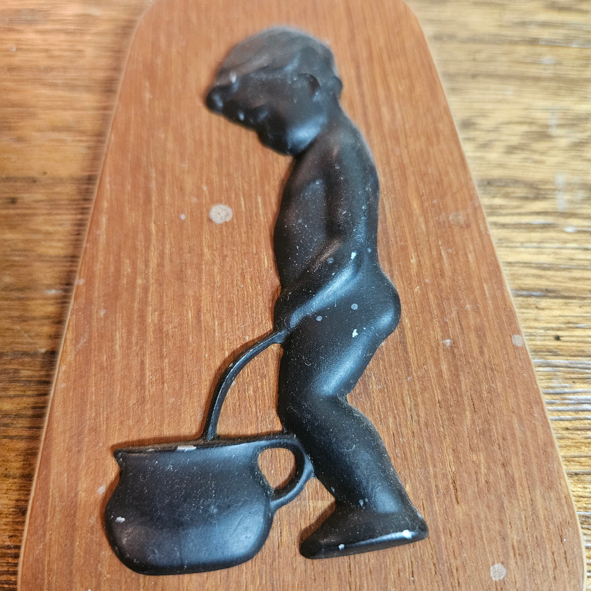 Wood Plaque with Black Figural Boy & Kettle