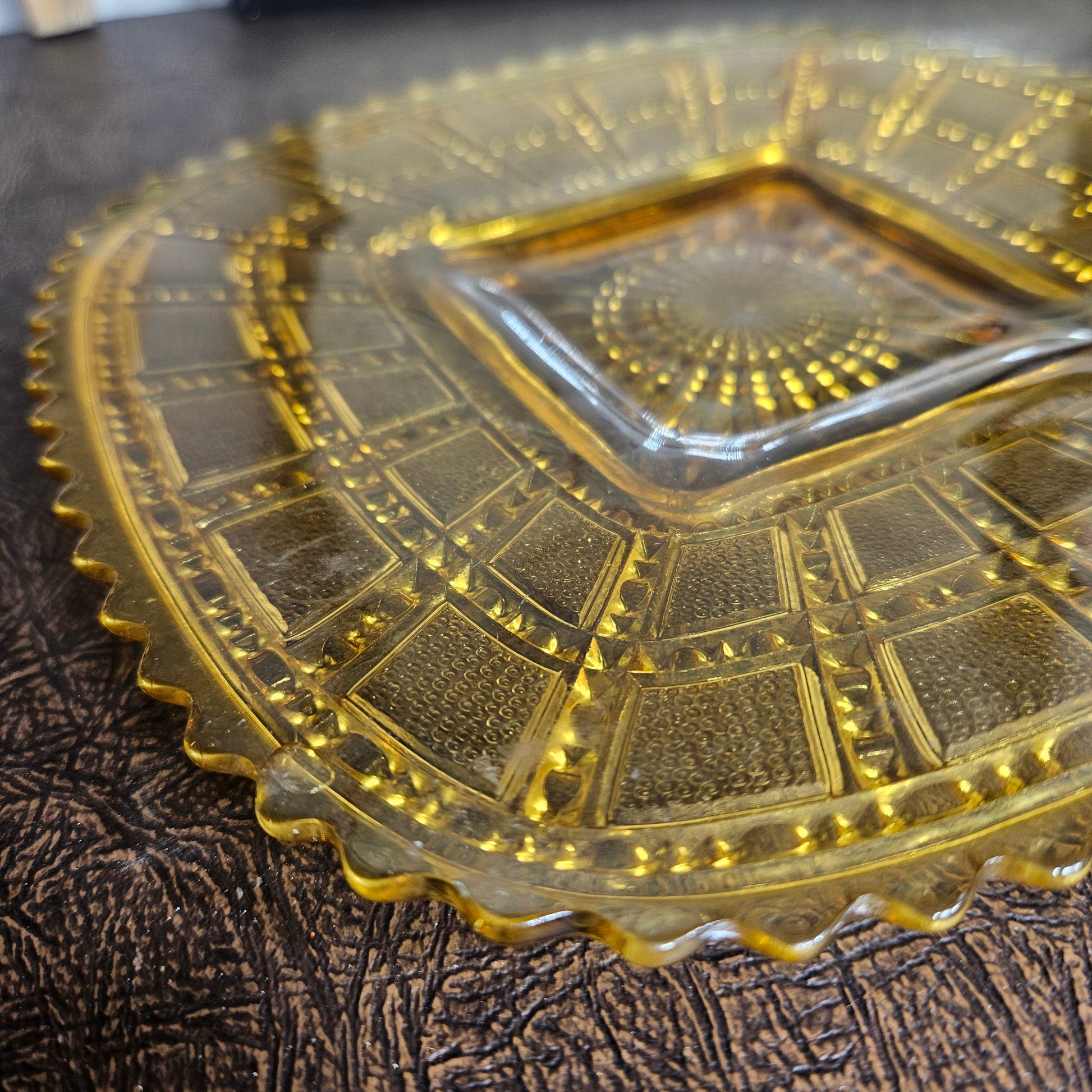 Vintage amber pressed glass bowl starburst pattern close up detail