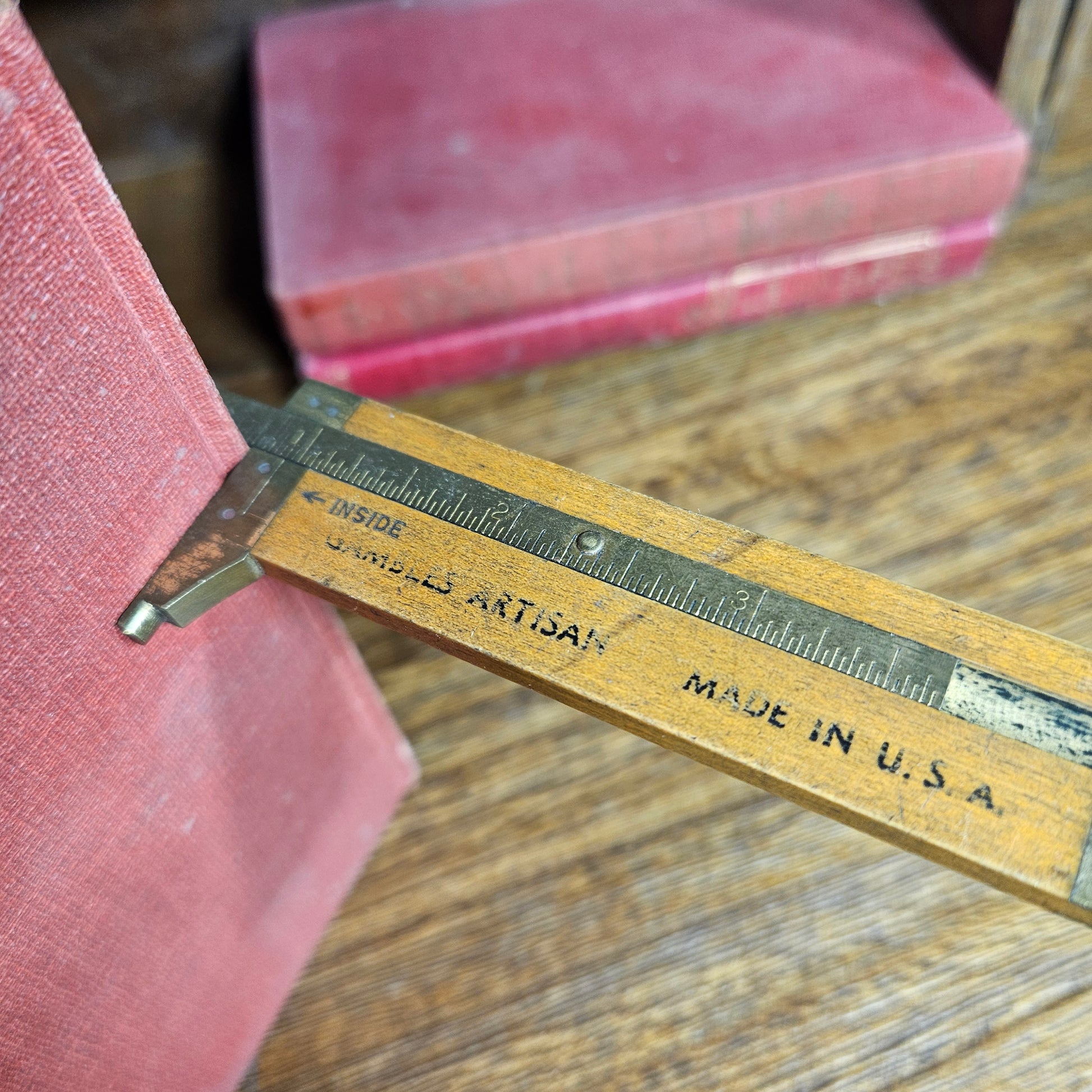 old wooden measuring gauge on wood surface