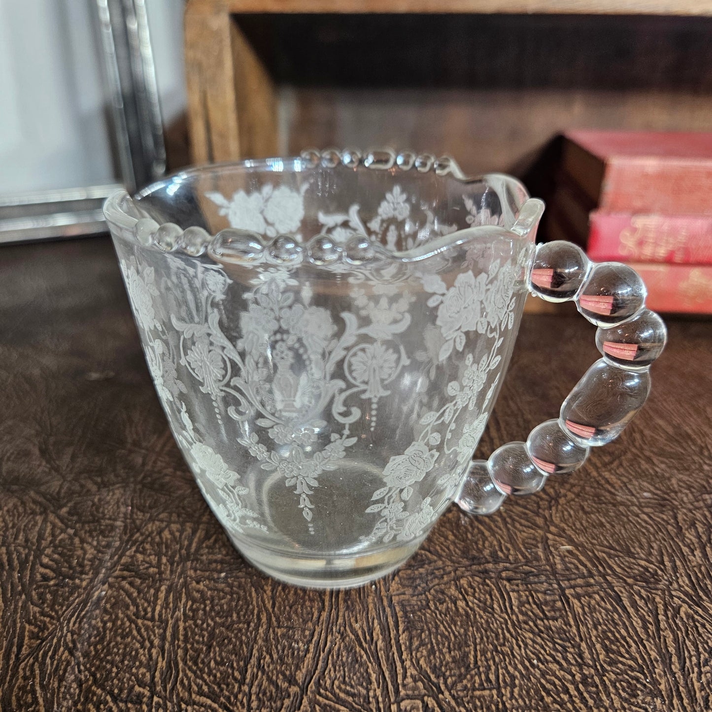 Vintage creamer with beaded handle and etched floral detail