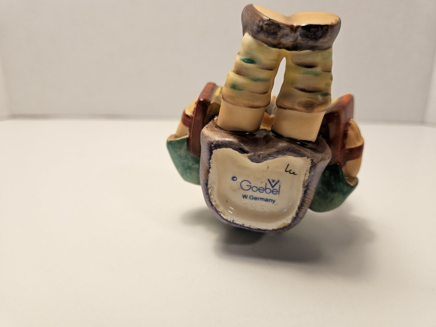 Ceramic sculpture of a foot with a Goebel logo on a white background