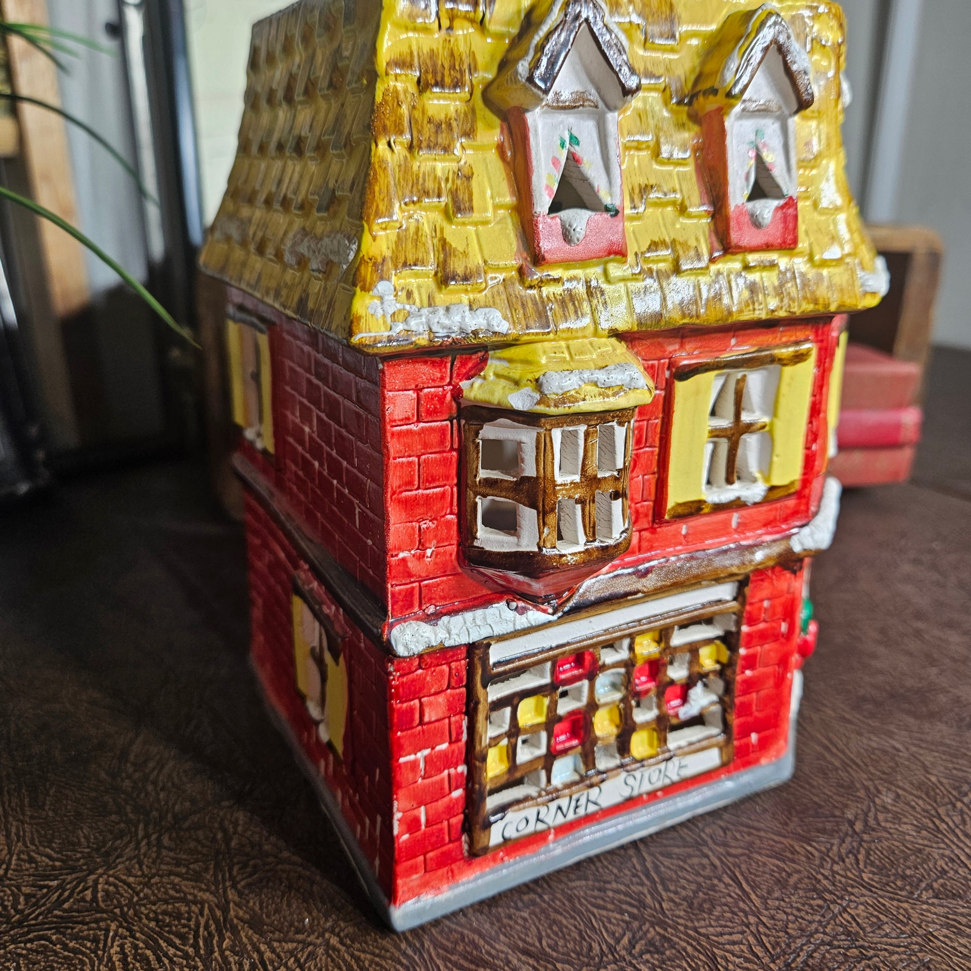 Small model of a building with colorful facade on a textured surface