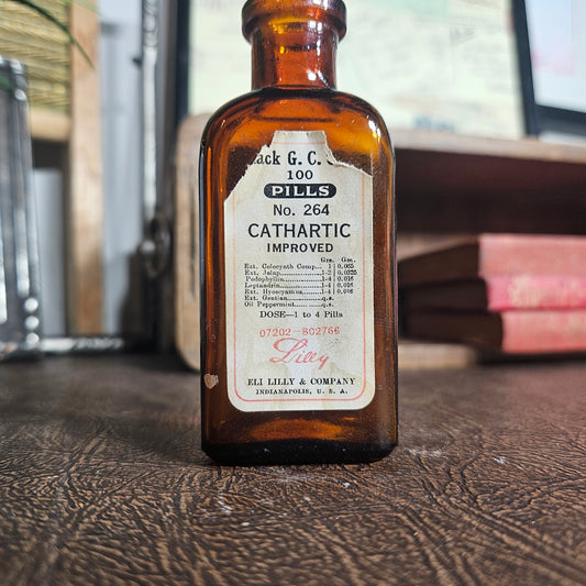 Vintage cathartic bottle with a label on a wooden surface