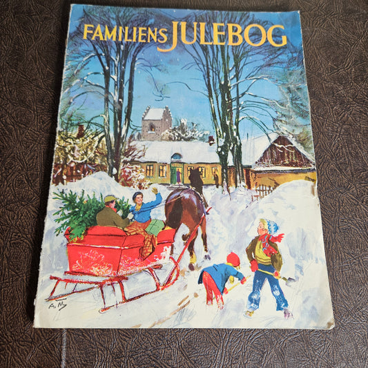 Front cover of Familiens Julebog with snowy winter scene