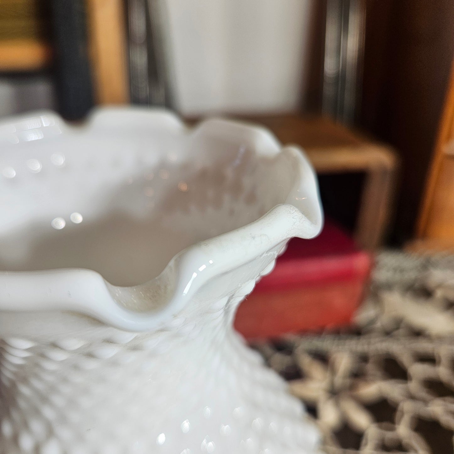 Close-up of a white hobnail glass
