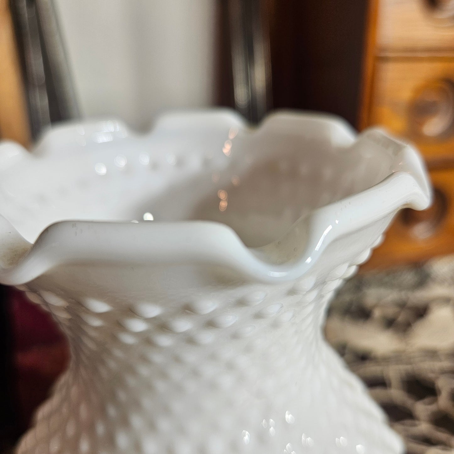 Close-up of a white glass lampshade with textured surface in a kitchen setting