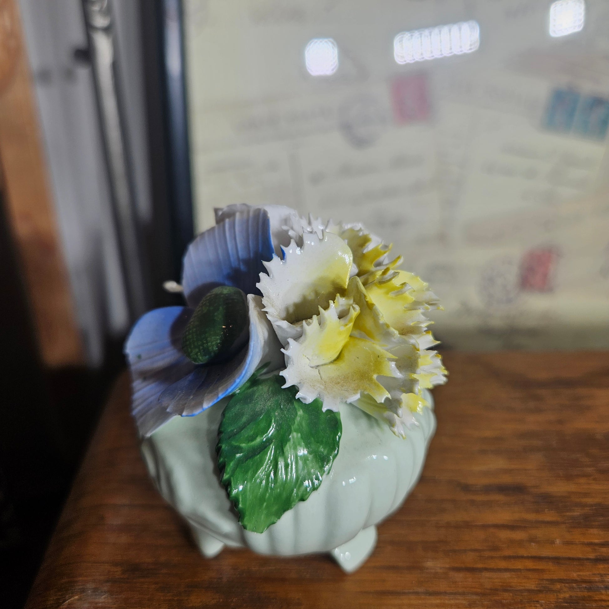 Decorative ceramic piece with blue and yellow flowers