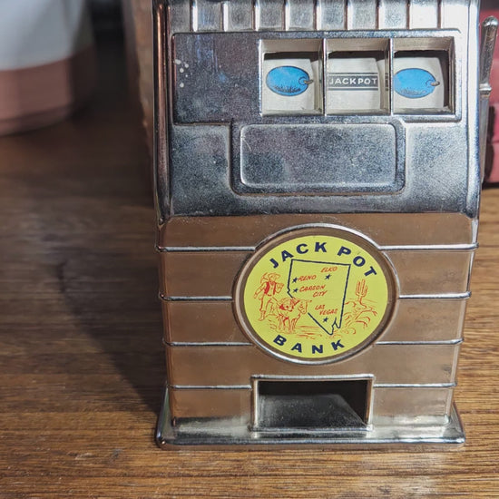 Close up front of working vintage casino themed coin bank
