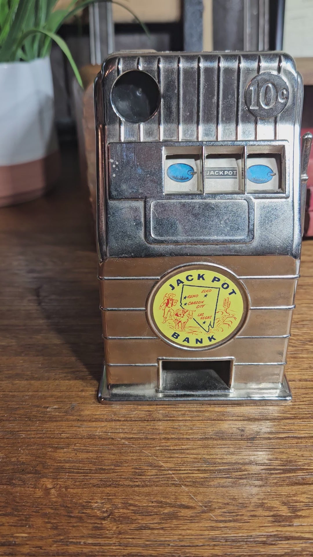 Close up front of working vintage casino themed coin bank