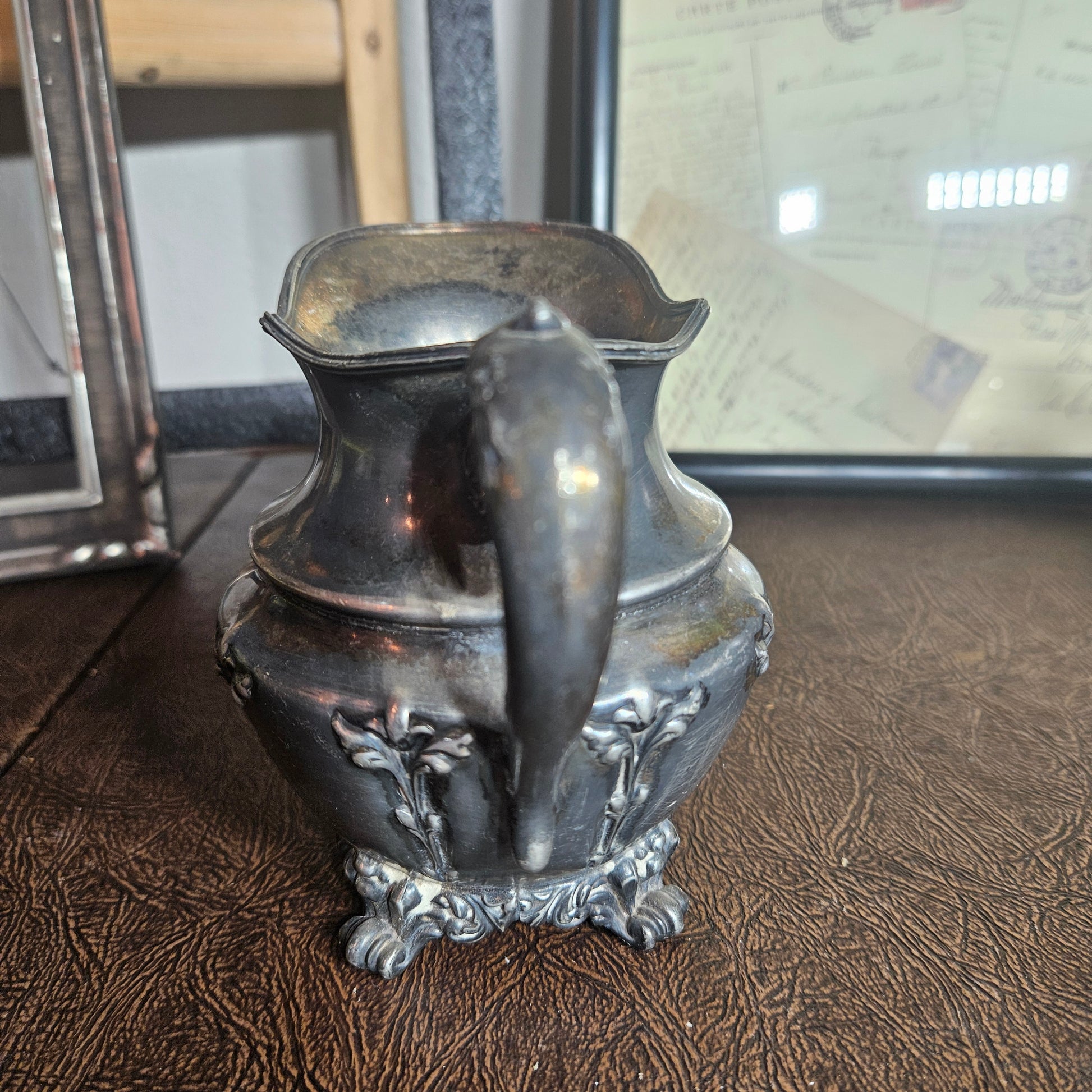 Vintage silverplate creamer and sugar bowl ornate set close up detail