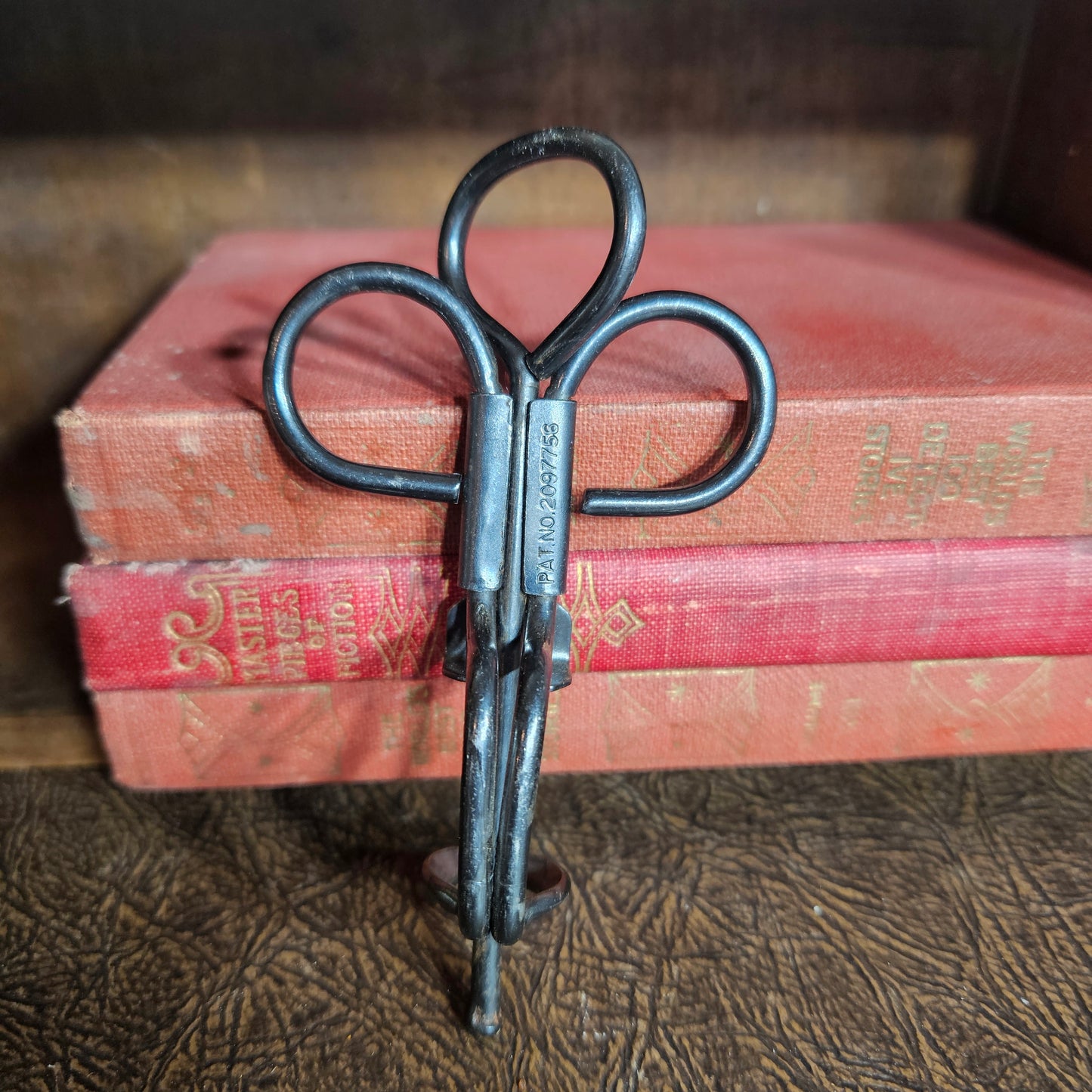 Vintage metal cherry pitter kitchen tool with hand press design