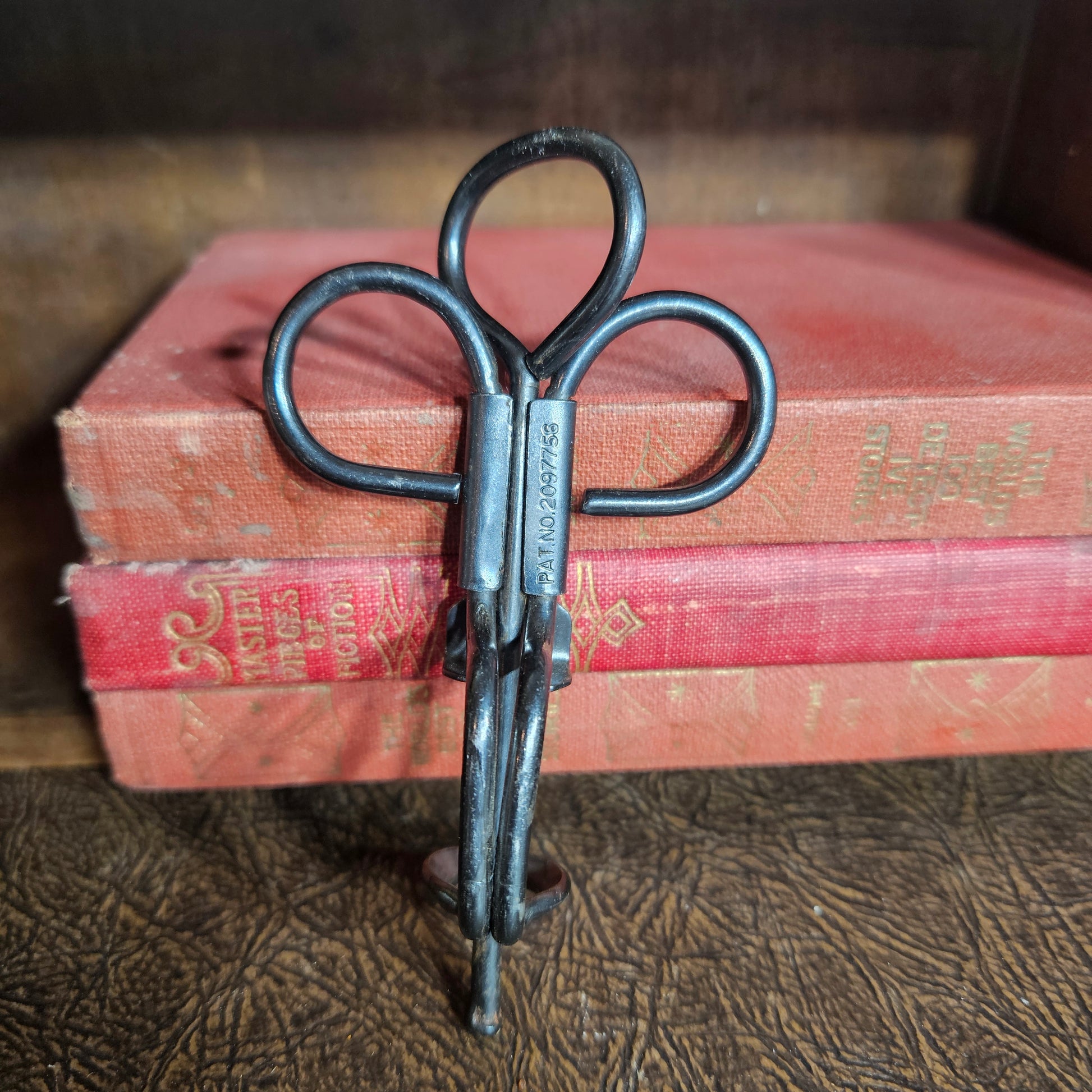 Vintage metal cherry pitter kitchen tool with hand press design
