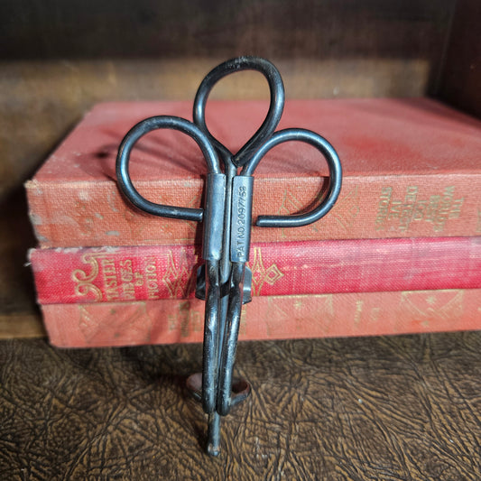 Vintage metal cherry pitter kitchen tool with hand press design